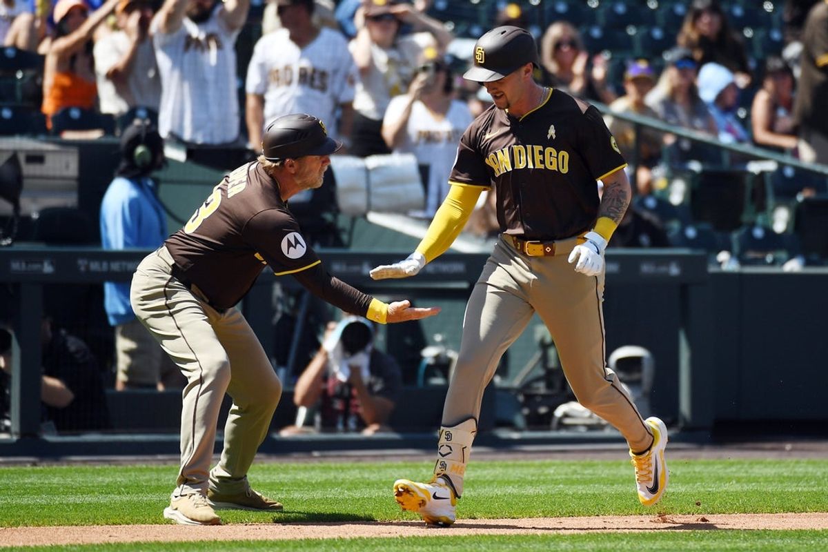 Sep 7, 2025; Denver, Colorado, USA; San Diego Padres outfielder Jackson Merrill (3) is congratulated by third base coach, infield & base running instructor Tim Leiper (33) after a home run during the second inning against the Colorado Rockies at Coors Field. Mandatory Credit: Christopher Hanewinckel-Imagn Images