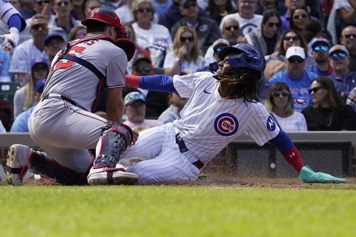 Sep 7, 2025; Chicago, Illinois, USA;  Washington Nationals catcher Riley Adams (15) tags out Chicago Cubs outfielder Kevin Alcántara (13) at home plate during the fifth inning Wrigley Field. Mandatory Credit: David Banks-Imagn Images