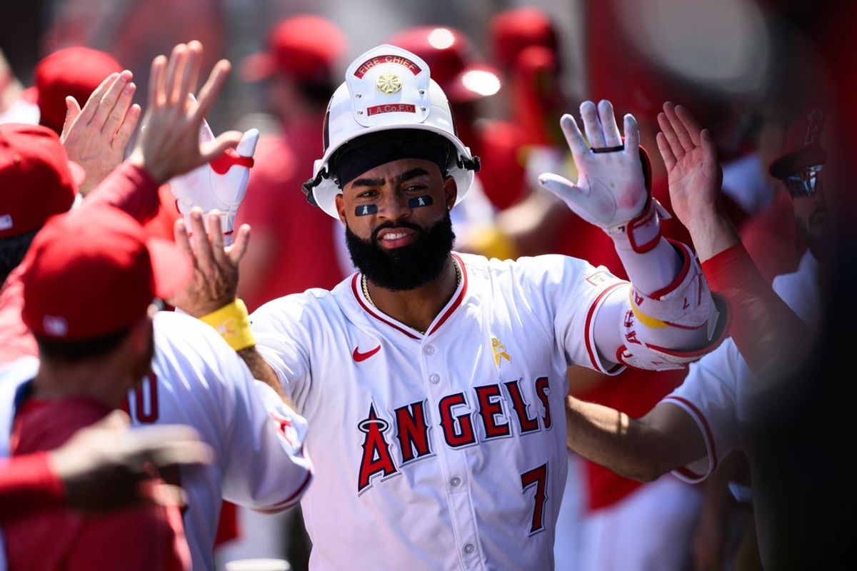 Sep 7, 2025; Anaheim, California, USA; Los Angeles Angels right fielder Jo Adell (7) is greeted by teammates after hitting a two run home run against the Athletics during the first inning at Angel Stadium. Mandatory Credit: William Liang-Imagn Images