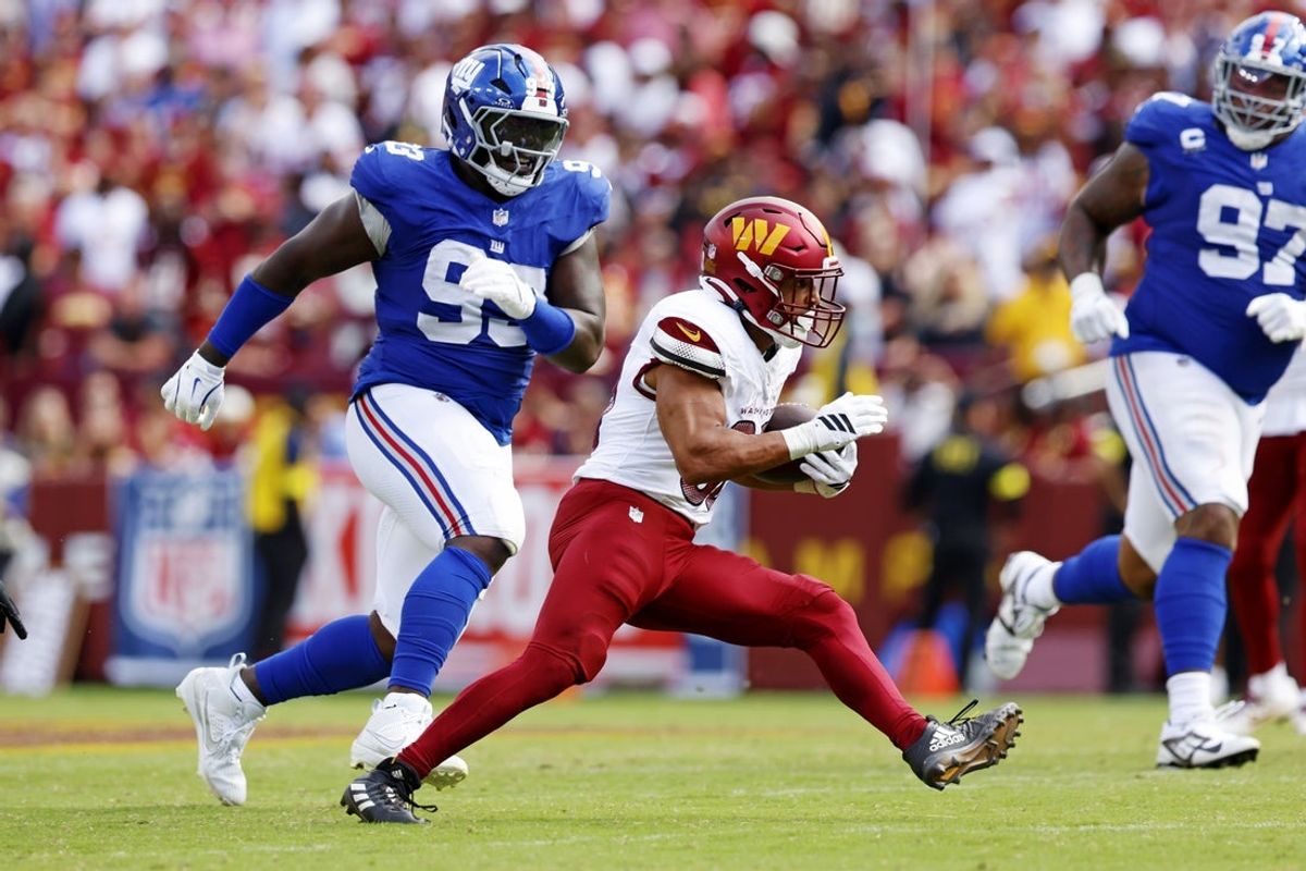 Sep 7, 2025; Landover, Maryland, USA; Washington Commanders running back Austin Ekeler (30) makes a run against the New York Giants during the fourth quarter at Northwest Stadium. Mandatory Credit: Peter Casey-Imagn Images