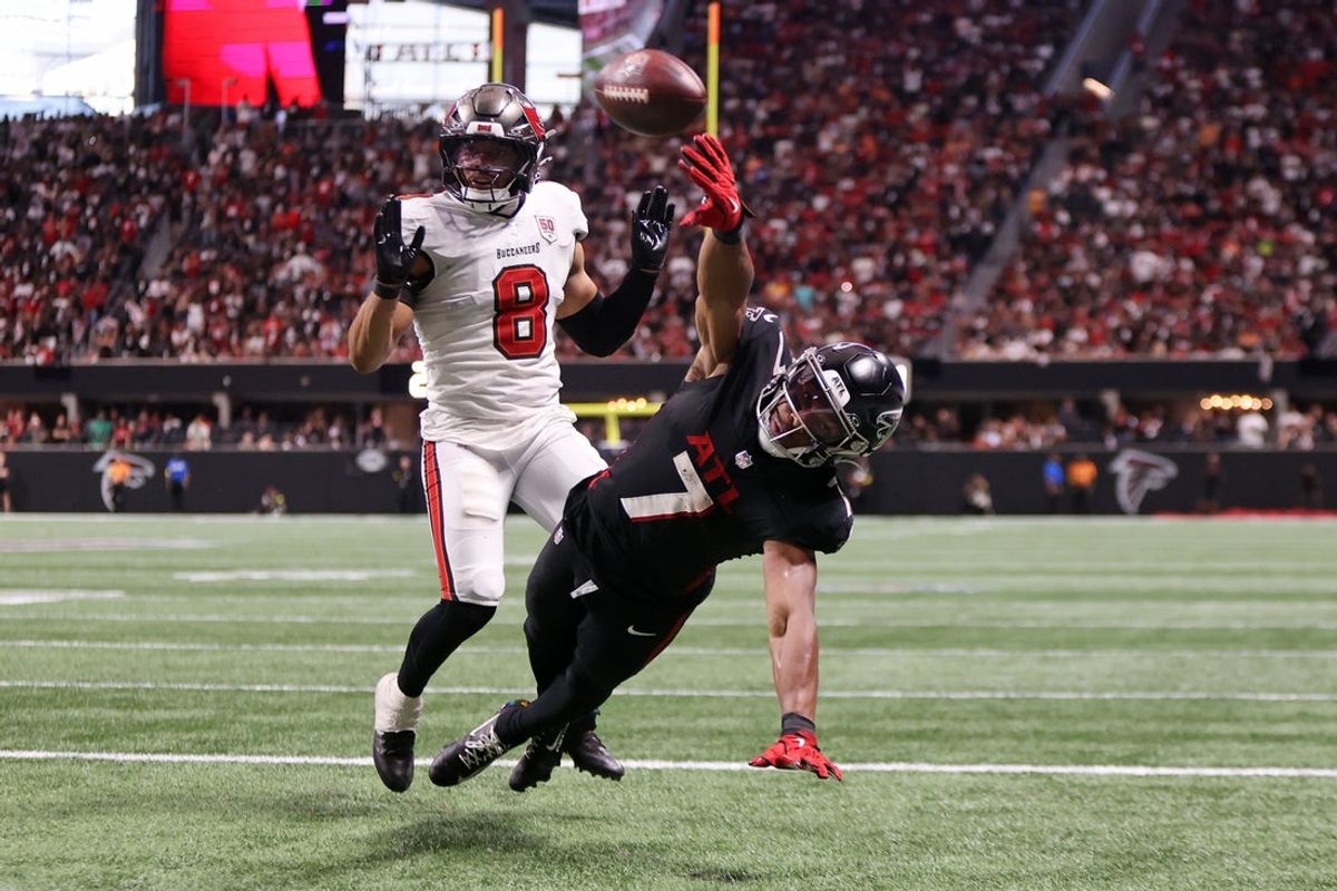 Sep 7, 2025; Atlanta, Georgia, USA; Atlanta Falcons running back Bijan Robinson (7) reaches for the ball against Tampa Bay Buccaneers linebacker SirVocea Dennis (8) during the fourth quarter at Mercedes-Benz Stadium. Mandatory Credit: Brett Davis-Imagn Images
