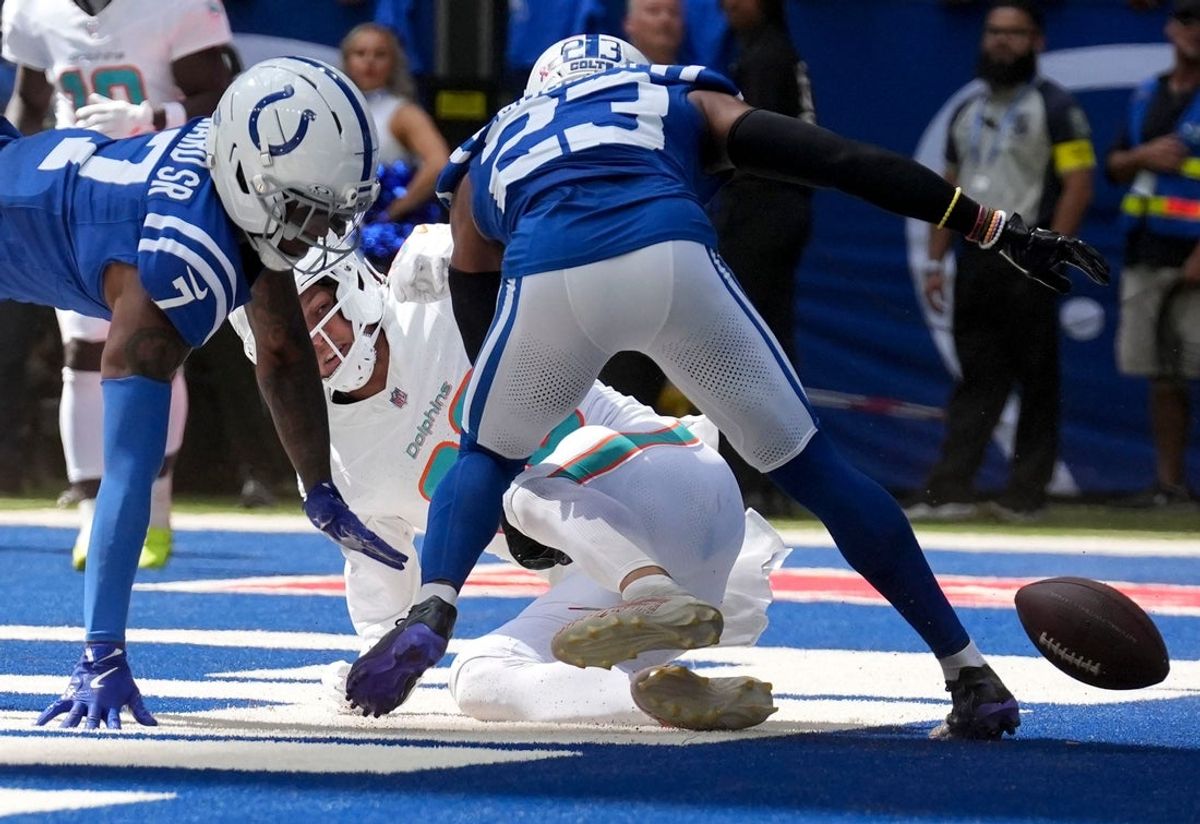 Indianapolis Colts cornerback Charvarius Ward Sr. (7) and cornerback Kenny Moore II (23) take down Miami Dolphins tight end Tanner Conner (80) as he misses a pass in the end zone during the second half of a game Sunday, Sept. 7, 2025, at Lucas Oil Stadium in Indianapolis. The Colts defeated the Dolphins 33-8.