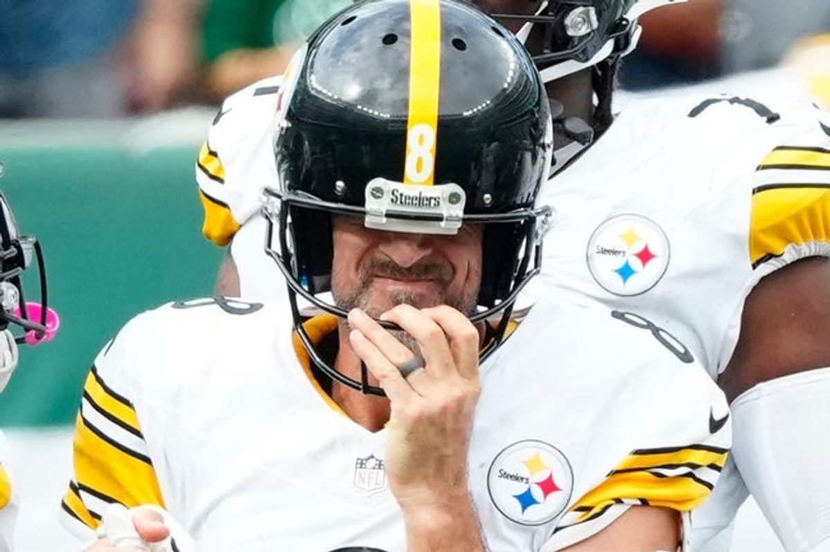 Pittsburgh Steelers quarterback Aaron Rodgers (8) gets his bearings after being sacked in the fourth quarter, Sunday, September 7, 2025, in East Rutherford.