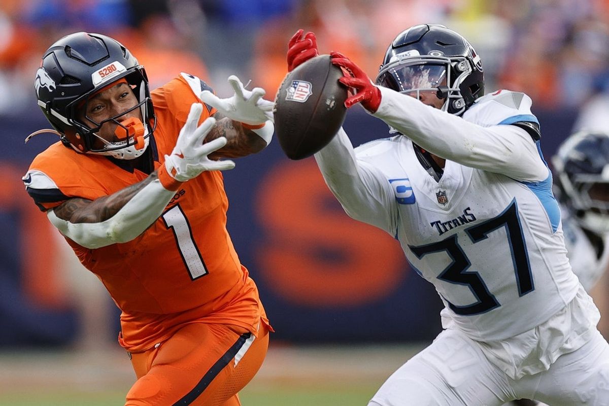 Sep 7, 2025; Denver, Colorado, USA; Tennessee Titans safety Amani Hooker (37) knocks the ball away from Denver Broncos tight end Evan Engram (1) in the first half at Empower Field at Mile High. Mandatory Credit: Isaiah J. Downing-Imagn Images