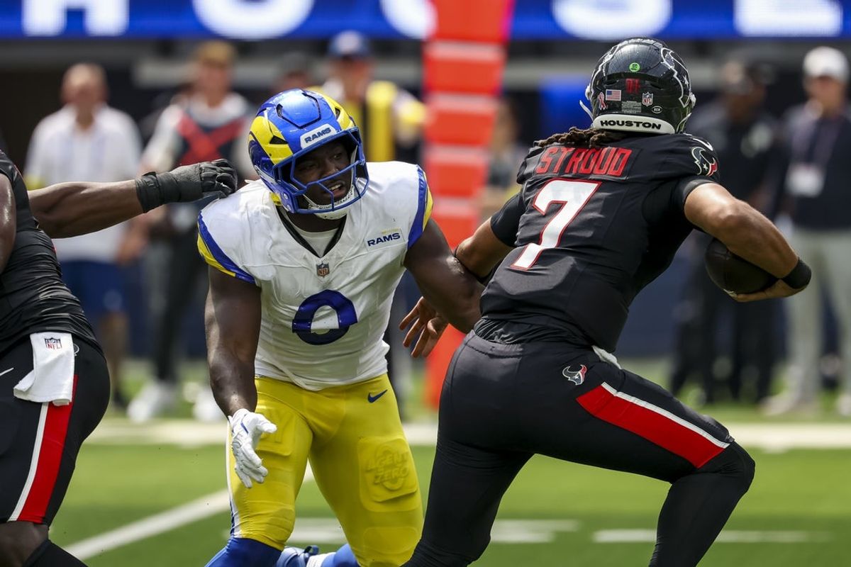 Sep 7, 2025; Inglewood, California, USA; Los Angeles Rams linebacker Byron Young (0) sacks Houston Texans quarterback C.J. Stroud (7) during the second quarter at SoFi Stadium. Mandatory Credit: Kiyoshi Mio-Imagn Images