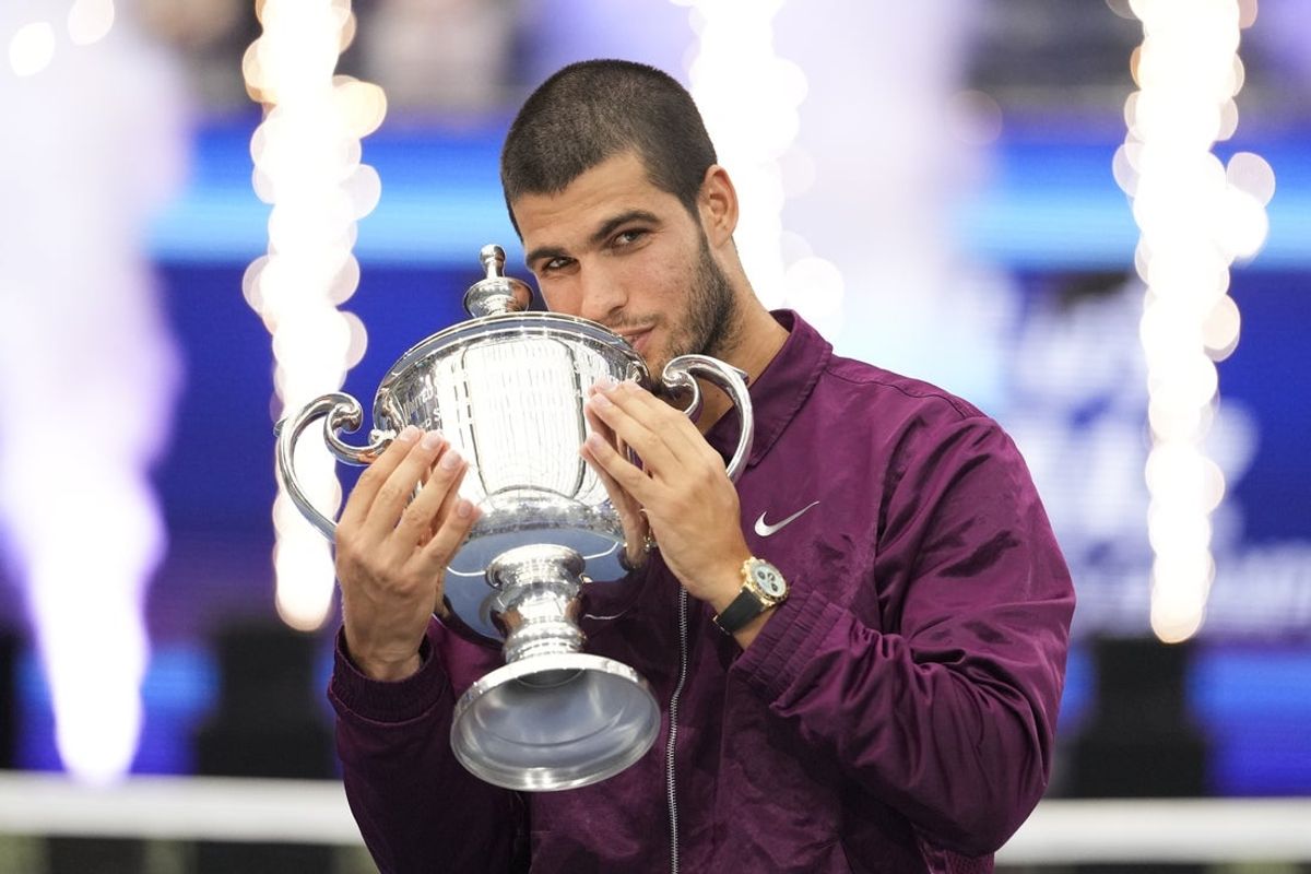 Sep 7, 2025; Flushing, NY, USA;  Carlos Alcaraz (ESP) kisses the trophy after defeating Jannik Sinner (ITA) (not pictured) in the final of mens singles at Billie Jean King National Tennis Center. Mandatory Credit: Robert Deutsch-Imagn Images