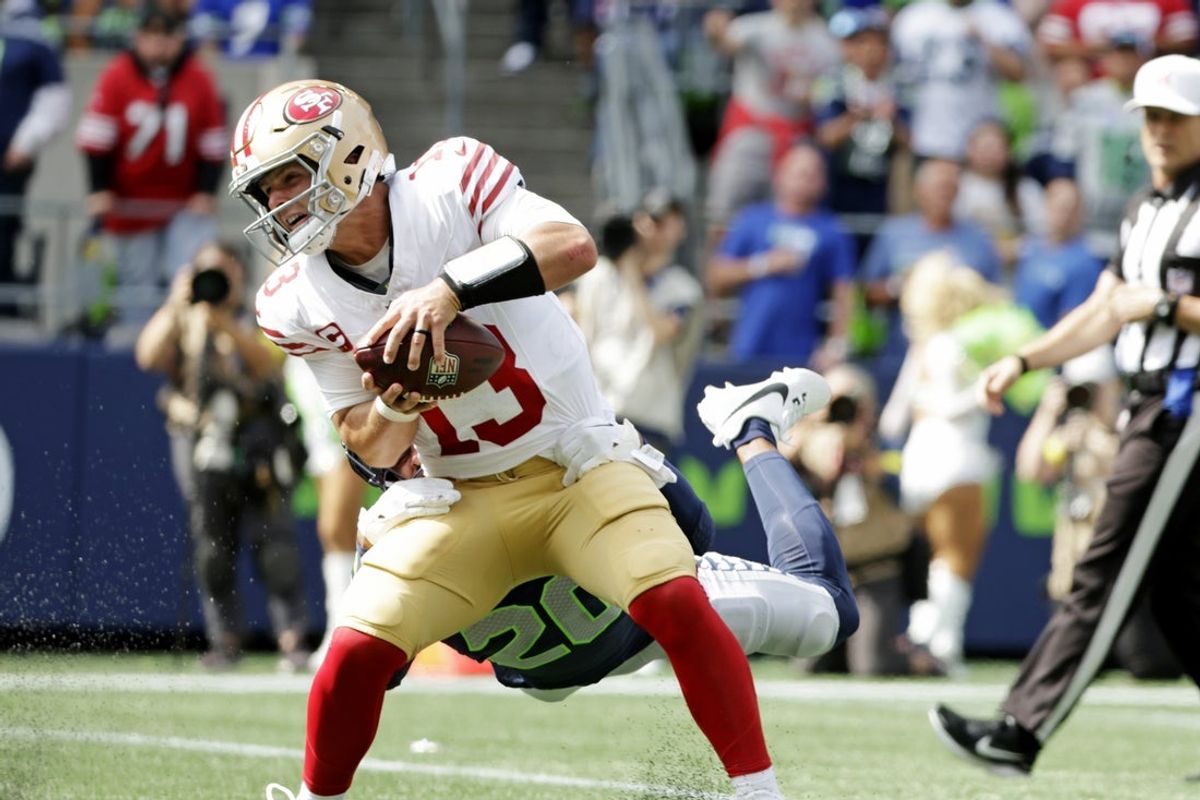 Sep 7, 2025; Seattle, Washington, USA; San Francisco 49ers quarterback Brock Purdy (13) runs the ball during the first half against the Seattle Seahawks at Lumen Field. Mandatory Credit: Joe Nicholson-Imagn Images