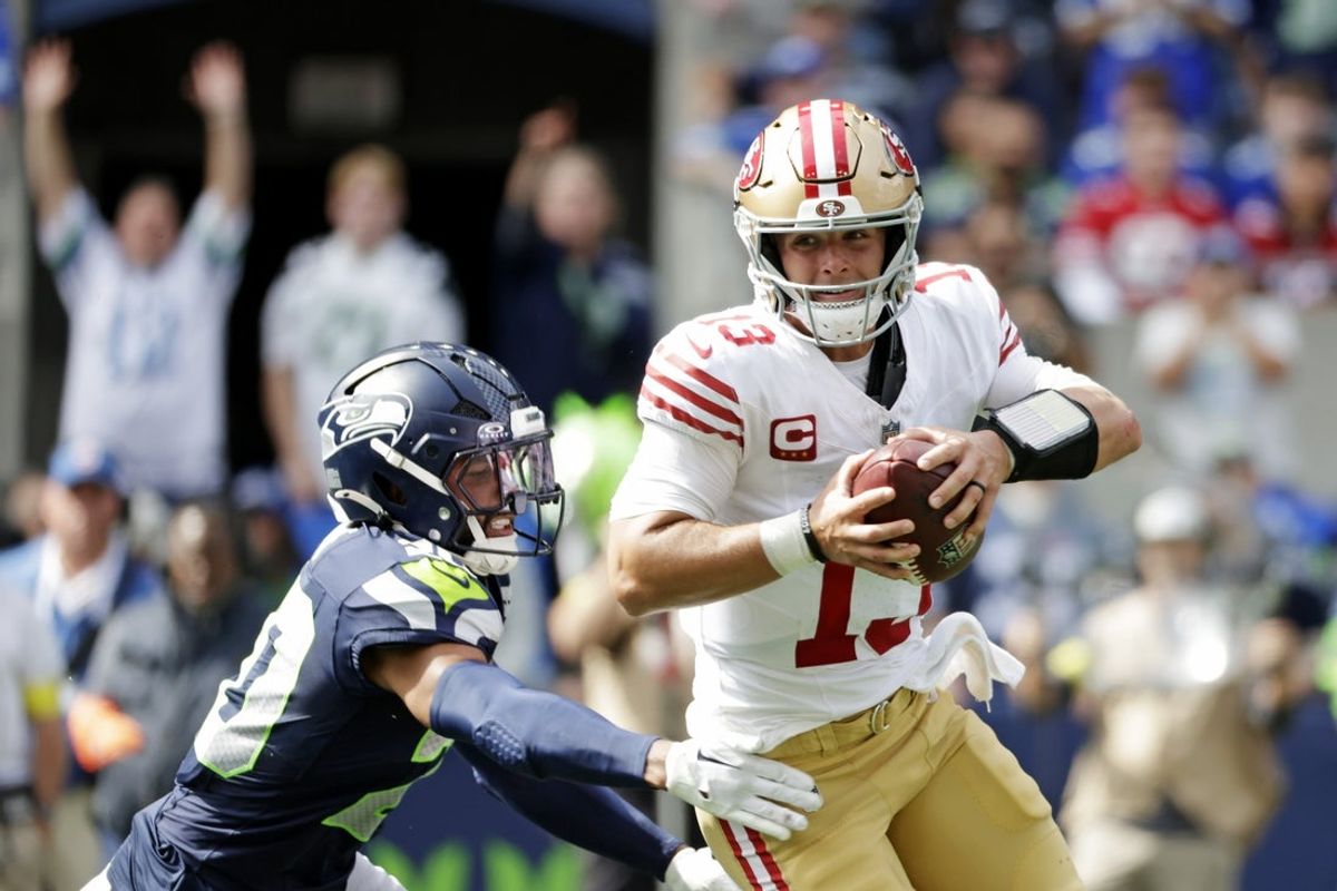 Sep 7, 2025; Seattle, Washington, USA; San Francisco 49ers quarterback Brock Purdy (13) runs the ball during the first half against the Seattle Seahawks at Lumen Field. Mandatory Credit: Joe Nicholson-Imagn Images