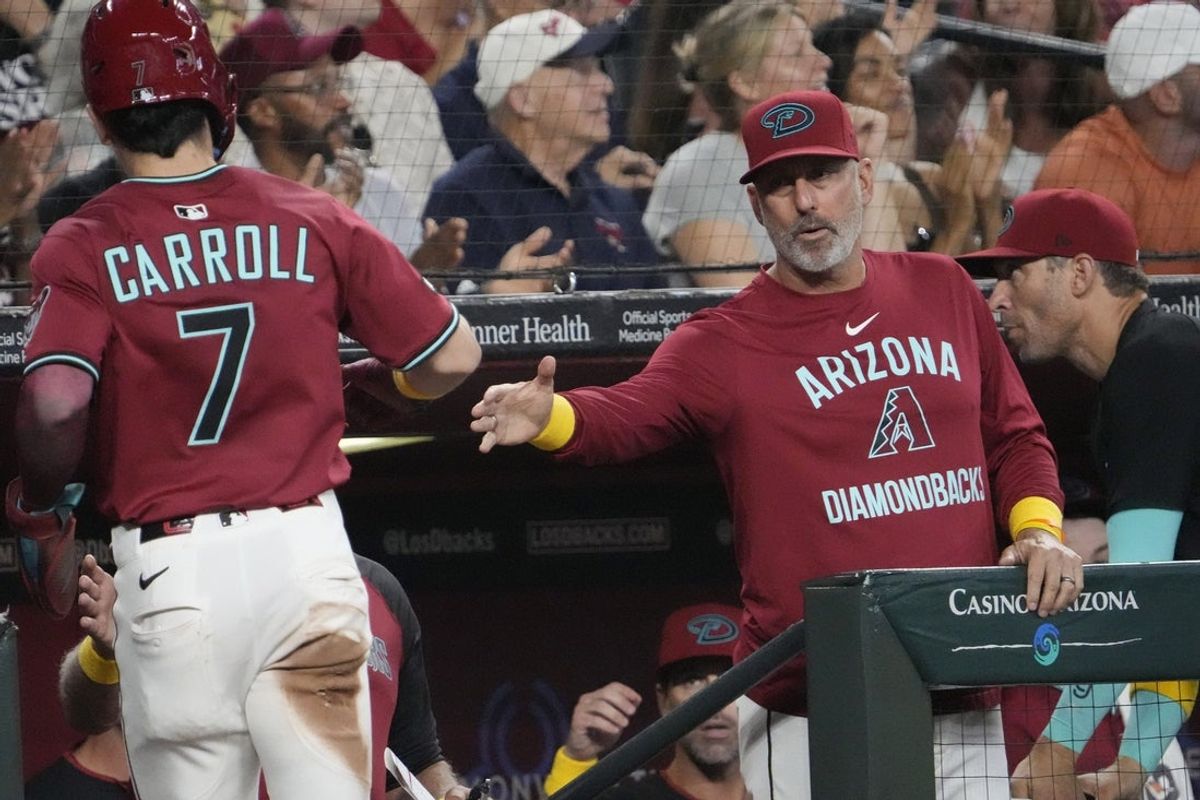 Arizona Diamondbacks manager Torey Lovullo (17) congratulates Corbin Carroll (7) after scoring against the Boston Red Sox during the sixth inning at Chase Field on Sept. 7, 2025.