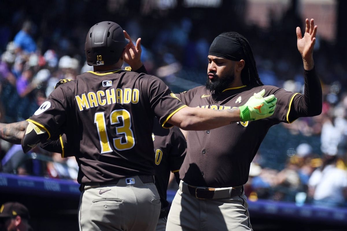 Sep 7, 2025; Denver, Colorado, USA; San Diego Padres third base Manny Machado (13) celebrates with outfielder Fernando Tatis Jr. (23) after a two-run home run during the first inning against the Colorado Rockies at Coors Field. Mandatory Credit: Christopher Hanewinckel-Imagn Images