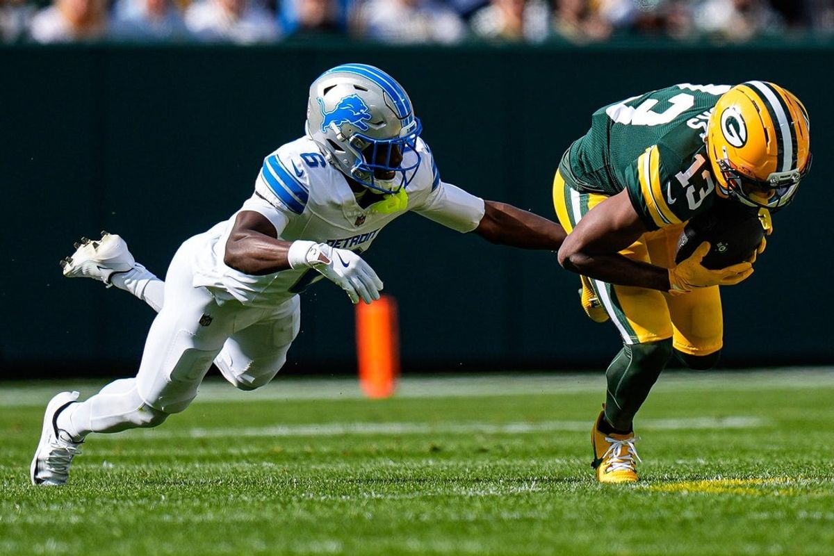 Green Bay Packers wide receiver Dontayvion Wicks (13) makes a catch against Detroit Lions cornerback Terrion Arnold (6) during the first half at Lambeau Field in Green Bay, Wis., on Sunday, September 7, 2025.