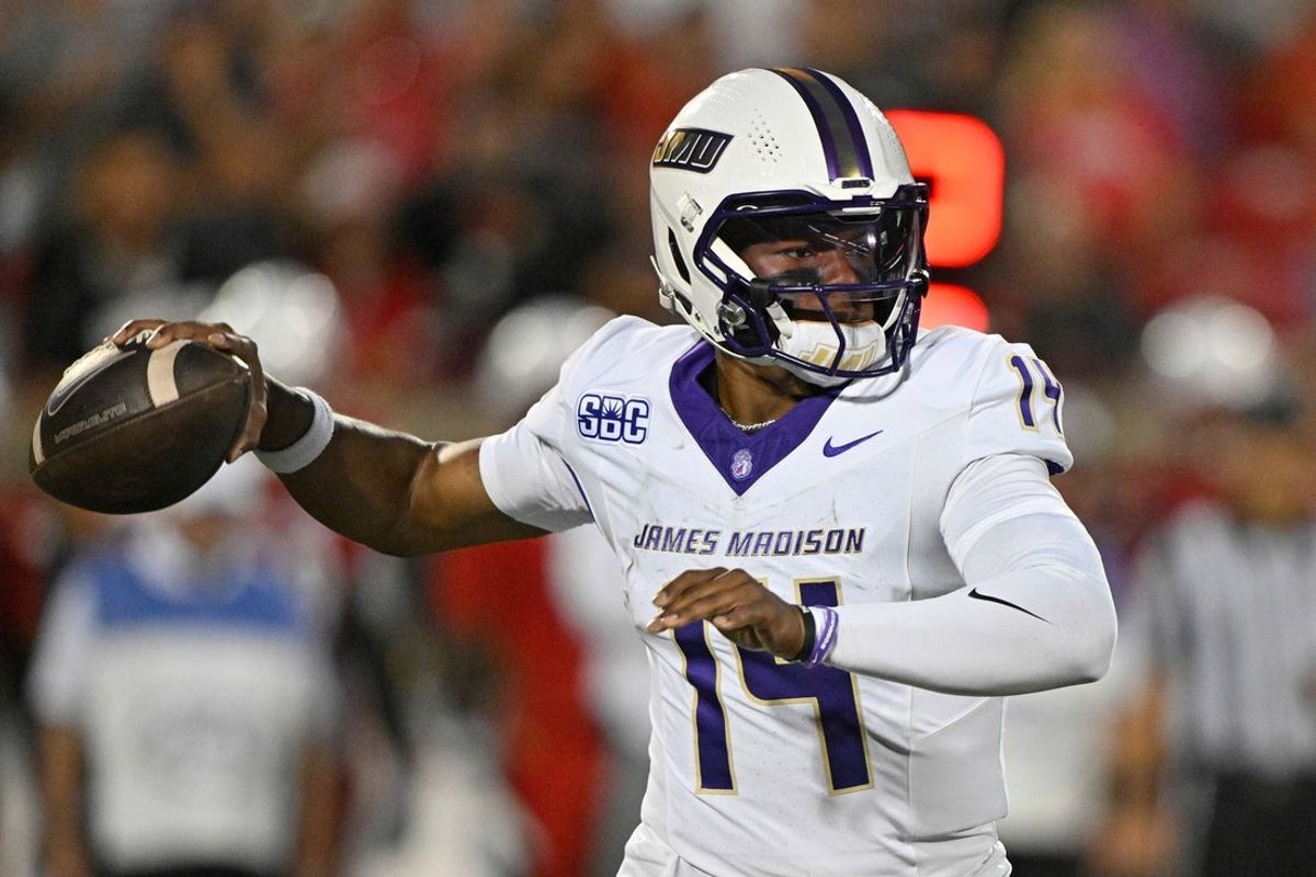 Sep 5, 2025; Louisville, Kentucky, USA;  James Madison Dukes quarterback Alonza Barnett III (14) looks to pass against the Louisville Cardinals during the first half at L&N Federal Credit Union Stadium. Louisville defeated James Madison 28-14. Mandatory Credit: Jamie Rhodes-Imagn Images
