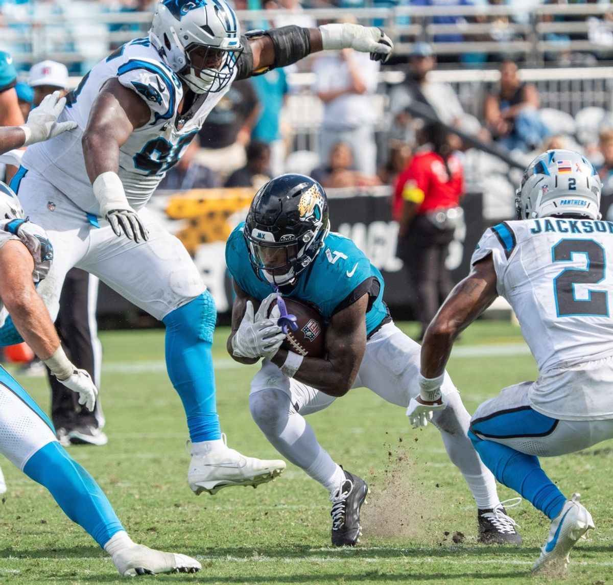 Jacksonville Jaguars running back Tank Bigsby (4) eludes Carolina Panthers defensive end Derrick Brown (95) an d Carolina Panthers cornerback Mike Jackson (2) on Sunday September 7, 2025. Bigsby was traded to the Eagles