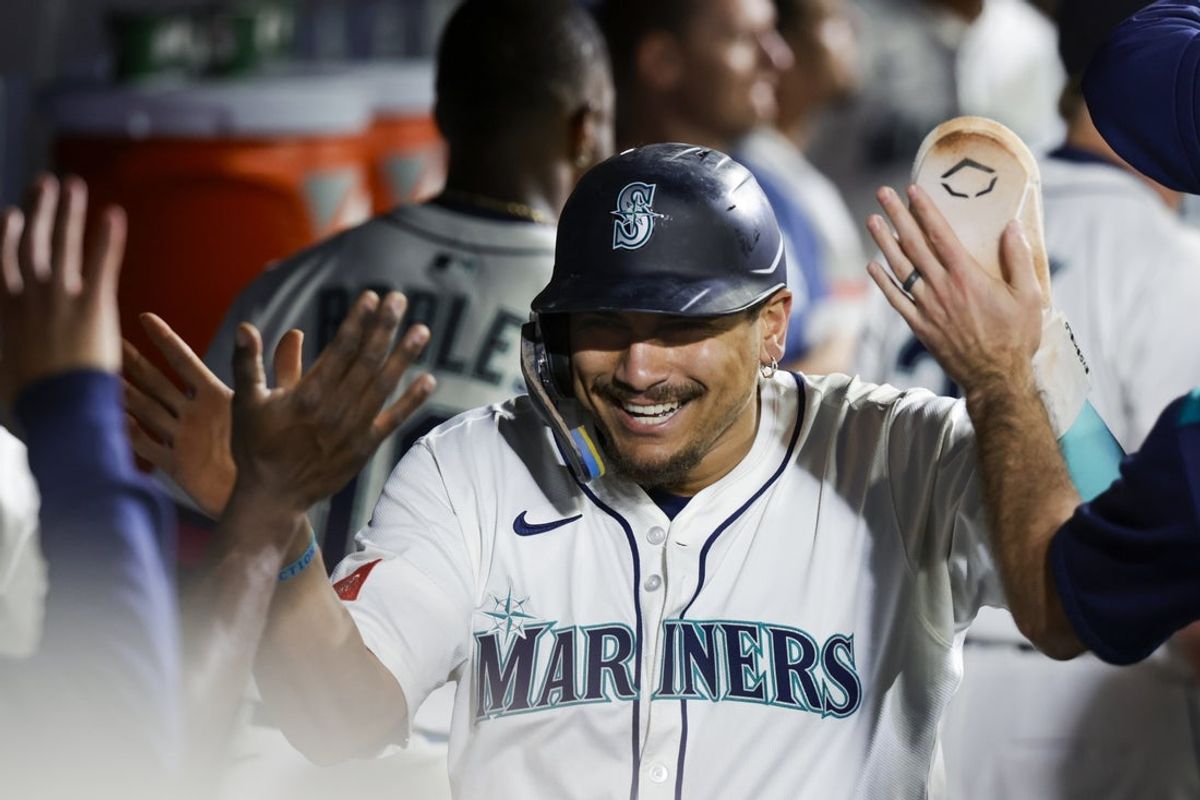 Sep 8, 2025; Seattle, Washington, USA; Seattle Mariners first baseman Josh Naylor (12) receives high-fives in the dugout after scoring a run against the St. Louis Cardinals during the sixth inning at T-Mobile Park. Mandatory Credit: Joe Nicholson-Imagn Images
