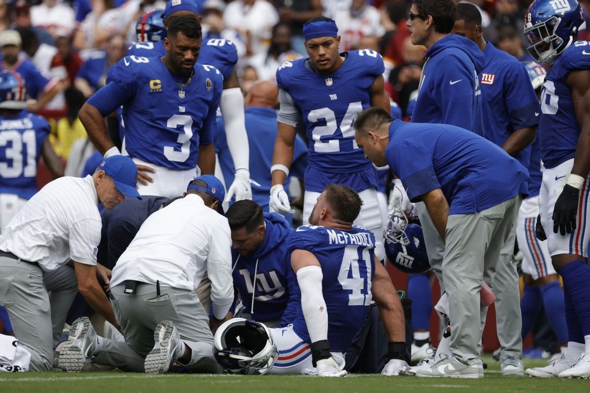 Sep 7, 2025; Landover, Maryland, USA; New York Giants linebacker Micah McFadden (41) is checked on by medical staff after being injured during the first quarter against the Washington Commanders at Northwest Stadium. Mandatory Credit: Amber Searls-Imagn Images