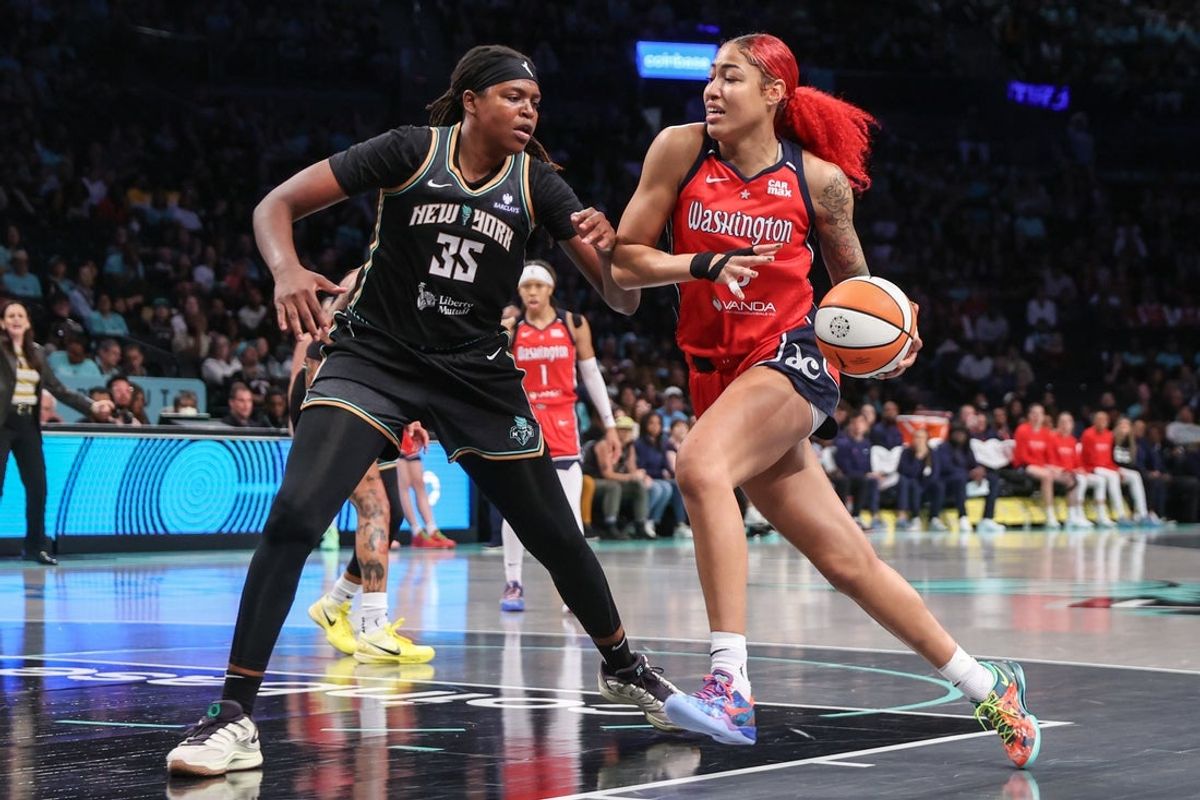 Sep 9, 2025; Brooklyn, New York, USA;  Washington Mystics forward Shakira Austin (0) looks to drive past New York Liberty center Jonquel Jones (35) in the first quarter at Barclays Center. Mandatory Credit: Wendell Cruz-Imagn Images