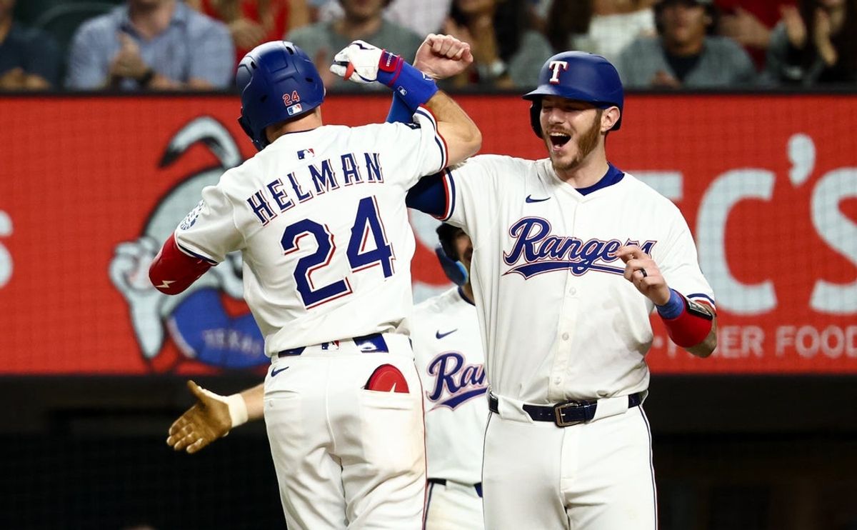 Sep 9, 2025; Arlington, Texas, USA;  Texas Rangers center fielder Michael Helman (24) celebrates with Texas Rangers catcher Jonah Heim (28) after hitting a two-run home run during the fifth inning against the Milwaukee Brewers at Globe Life Field. Mandatory Credit: Kevin Jairaj-Imagn Images