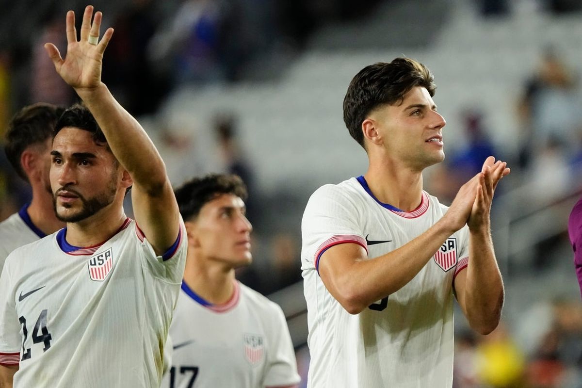 United States defender Max Arfsten (18) and midfielder Cristian Roldan (24) salute the fans following the 2-0 win over Japan in an international friendly soccer match at Lower.com Field in Columbus on Sept. 9, 2025.