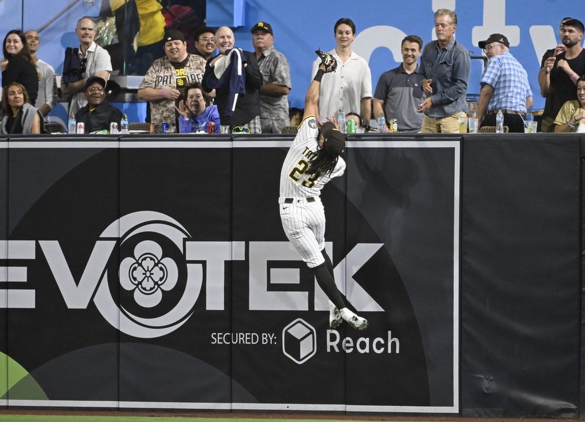 Sep 9, 2025; San Diego, California, USA; San Diego Padres right fielder Fernando Tatis Jr. (23) makes the catch on a ball hit by Cincinnati Reds catcher Tyler Stephenson (37) during the fourth inning at Petco Park. Mandatory Credit: Denis Poroy-Imagn Images