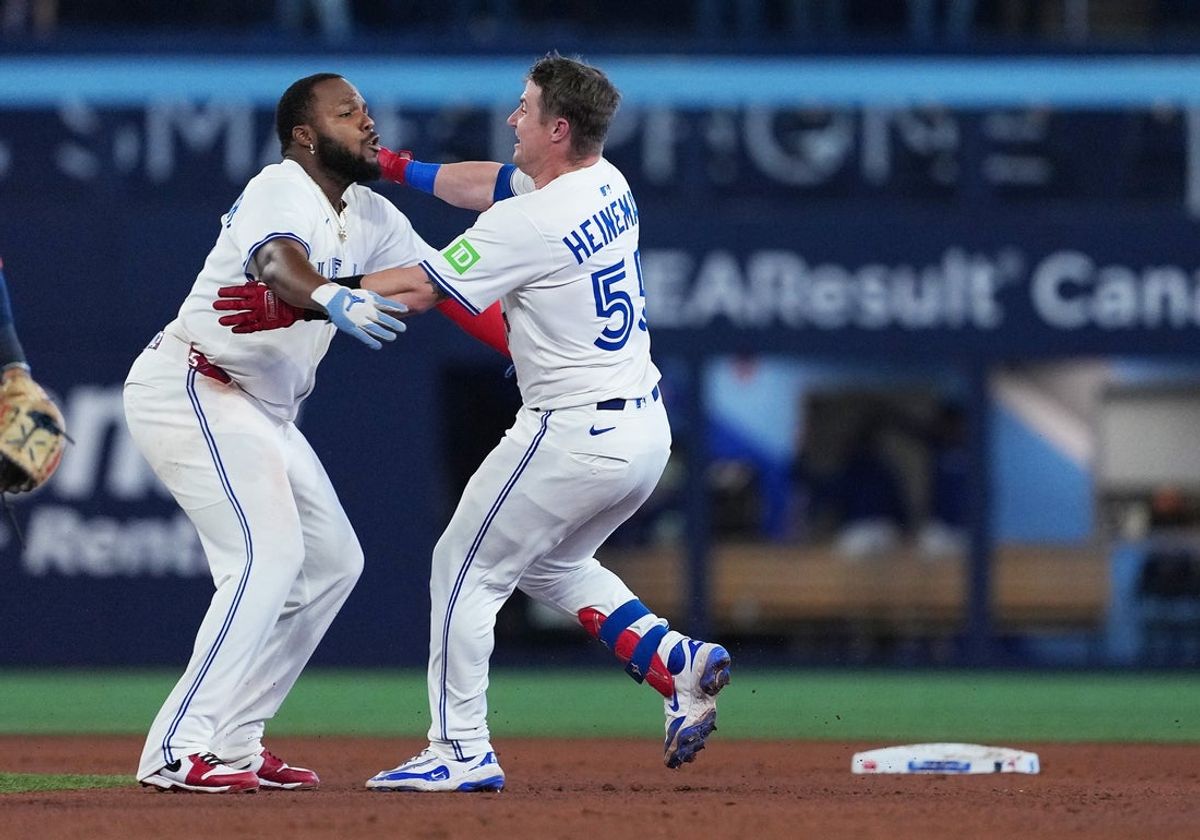 Sep 9, 2025; Toronto, Ontario, CAN; Toronto Blue Jays catcher Tyler Heineman (55) celebrates hitting into a fielders choice RBI with first base Vladimir Guerrero Jr. (27) against the Houston Astros during the the tenth inning at Rogers Centre. Mandatory Credit: Nick Turchiaro-Imagn Images