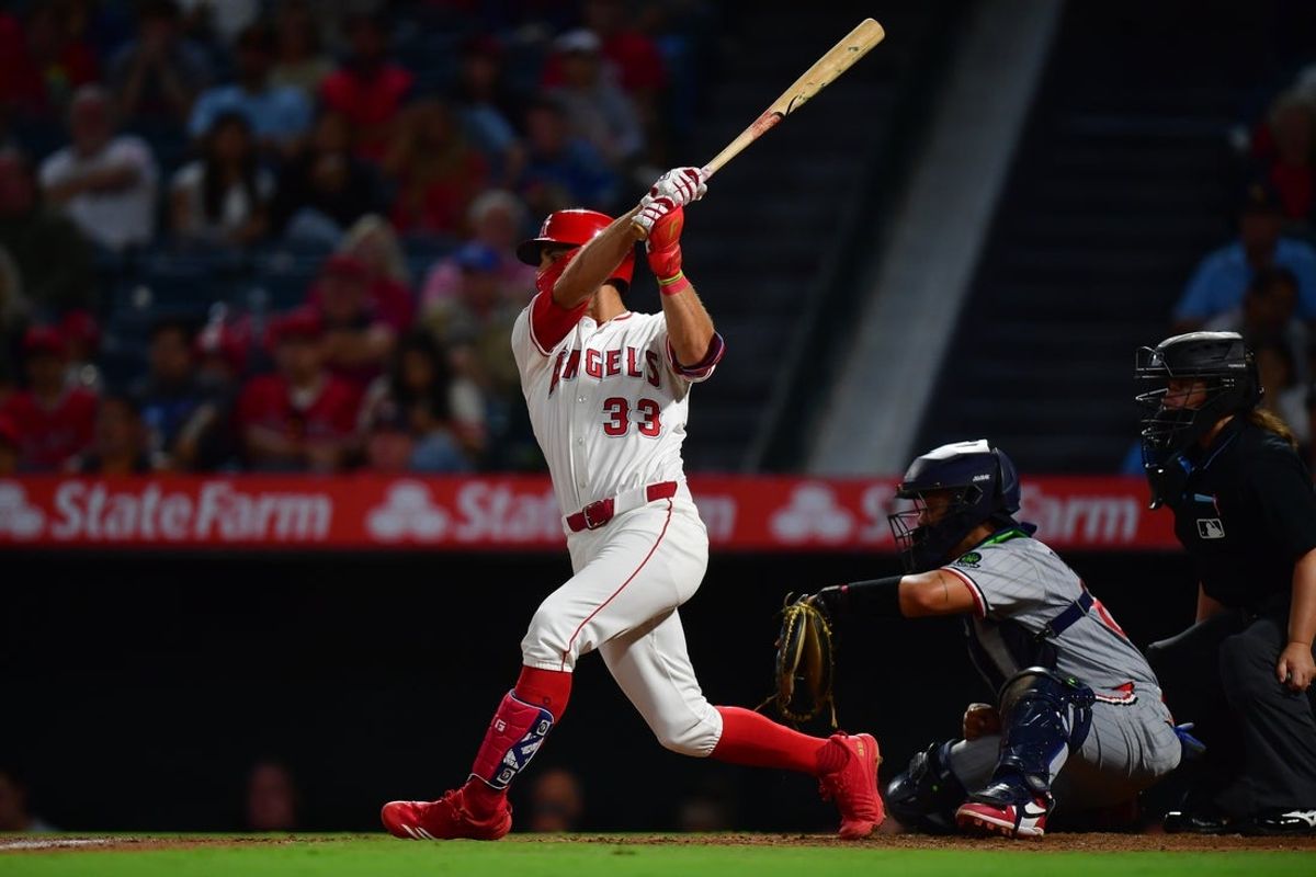 Sep 9, 2025; Anaheim, California, USA; Los Angeles Angels right fielder Chris Taylor (33) hits an RBI single against the Minnesota Twins during the fifth inning at Angel Stadium. Mandatory Credit: Gary A. Vasquez-Imagn Images