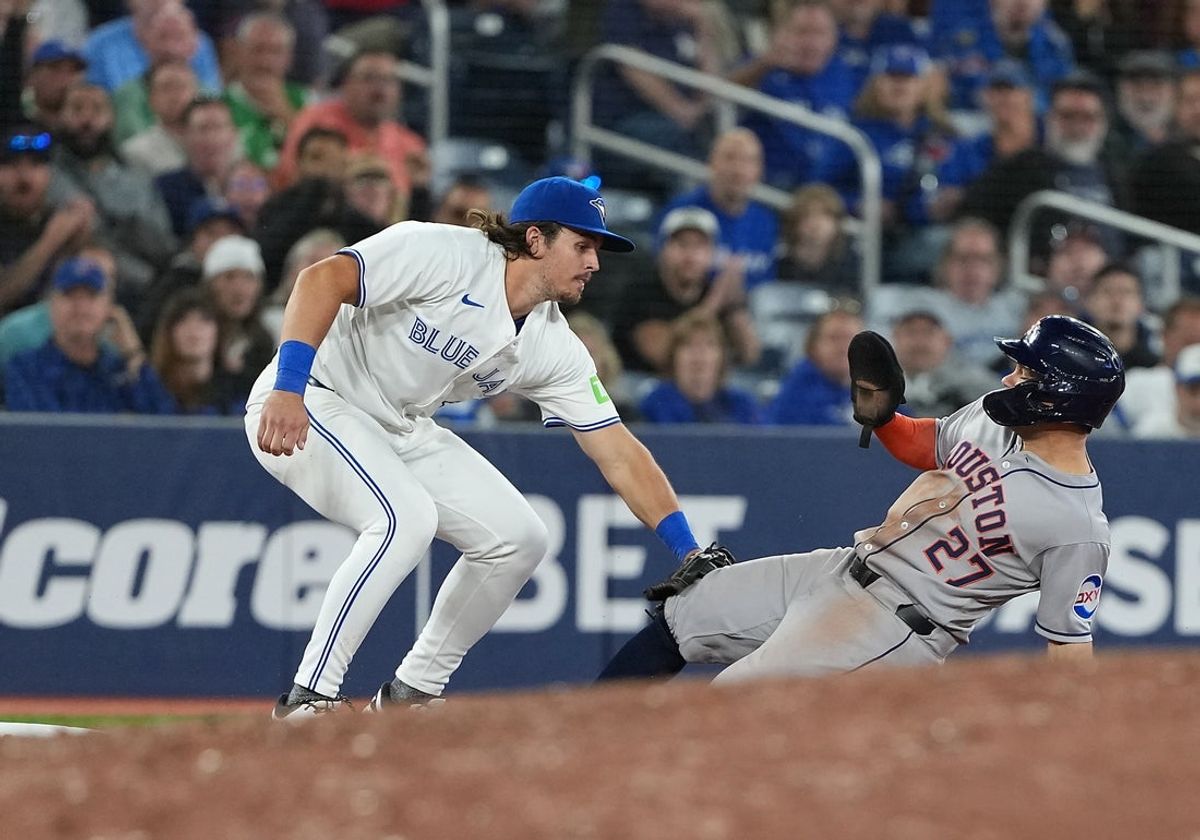 Sep 9, 2025; Toronto, Ontario, CAN; Toronto Blue Jays third baseman Addison Barger (47) tags out Houston Astros second baseman Jose Altuve (27) during the tenth inning at Rogers Centre. Mandatory Credit: Nick Turchiaro-Imagn Images