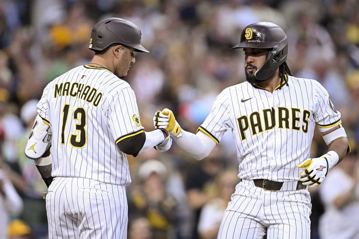 Sep 10, 2025; San Diego, California, USA; San Diego Padres right fielder Fernando Tatis Jr. (23) is congratulated by third baseman Manny Machado (13) after hitting a solo home run during the fifth inning against the Cincinnati Reds at Petco Park. Mandatory Credit: Denis Poroy-Imagn Images