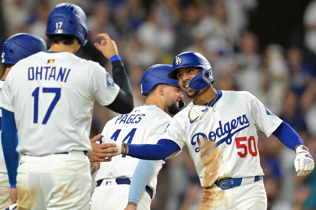 Sep 10, 2025; Los Angeles, California, USA; Los Angeles Dodgers shortstop Mookie Betts (50) is greeted at the plate by designated hitter Shohei Ohtani (17) after hitting a grand slam home run during the eighth inning against the Colorado Rockies at Dodger Stadium. Mandatory Credit: Jayne Kamin-Oncea-Imagn Images