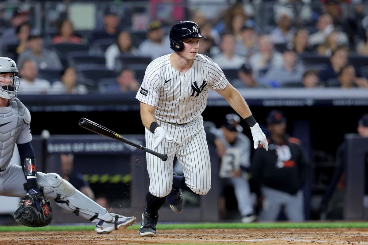 Sep 11, 2025; Bronx, New York, USA; New York Yankees catcher Ben Rice (22) follows through on an RBI double against the Detroit Tigers during the second inning at Yankee Stadium. Mandatory Credit: Brad Penner-Imagn Images