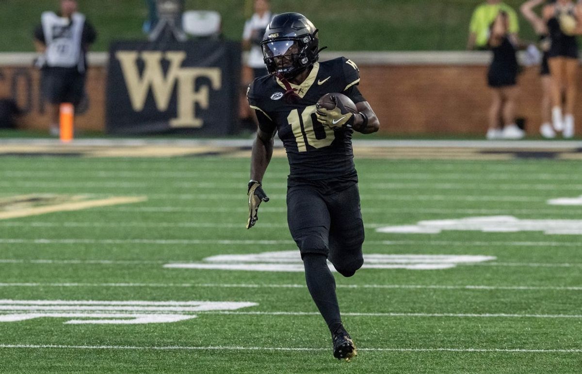 Sep 11, 2025; Winston-Salem, North Carolina, USA;  Wake Forest Demon Deacons wide receiver Chris Barnes (10) returns the opening kickoff for a touchdown in the first half against North Carolina State Wolfpack at Allegacy Federal Credit Union Stadium. Mandatory Credit: Luke Jamroz-Imagn Images
