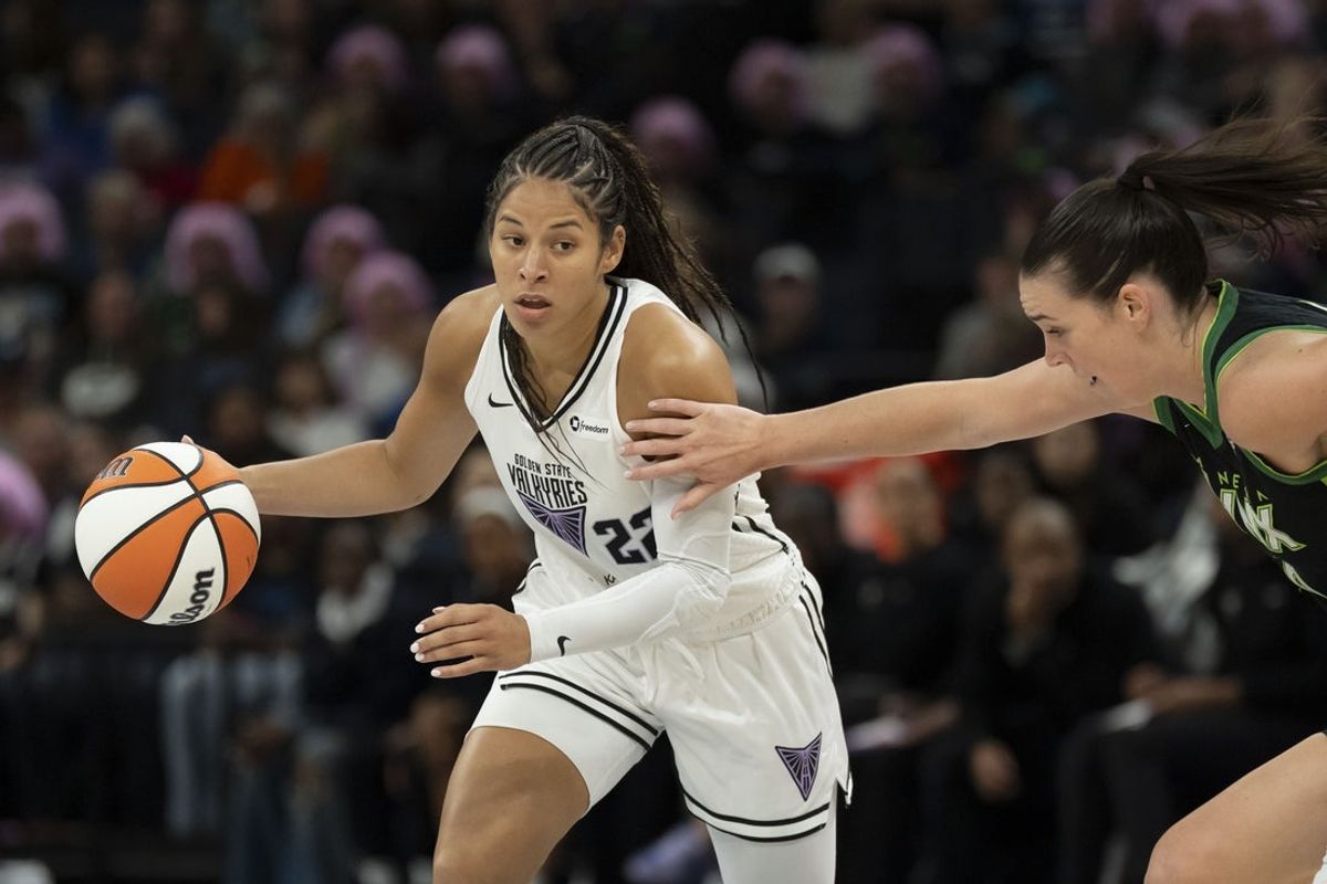 Sep 11, 2025; Minneapolis, Minnesota, USA; Golden State Valkyries guard Veronica Burton (22) dribbles past Minnesota Lynx forward Bridget Carleton (6) in the first half at Target Center. Mandatory Credit: Jesse Johnson-Imagn Images