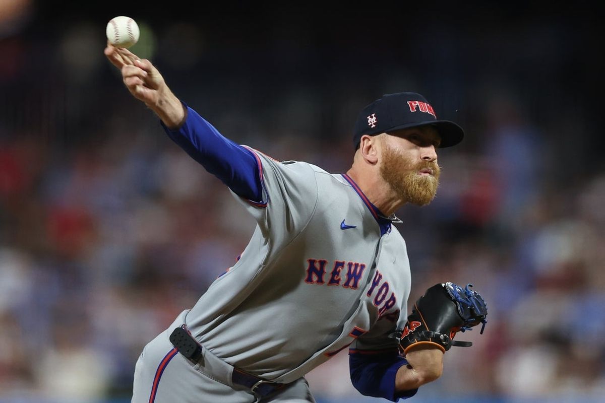 Sep 11, 2025; Philadelphia, Pennsylvania, USA; New York Mets pitcher Reed Garrett (75) shows a pitch against the Philadelphia Phillies during the sixth inning at Citizens Bank Park. Mandatory Credit: Bill Streicher-Imagn Images
