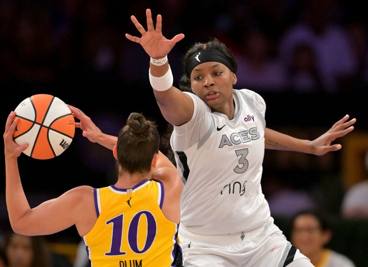 Sep 11, 2025; Los Angeles, California, USA; Los Angeles Sparks guard Kelsey Plum (10) looks to take a shot as she is defended by Las Vegas Aces forward NaLyssa Smith (3) during the first half at Crypto.com Arena. Mandatory Credit: Jayne Kamin-Oncea-Imagn Images
