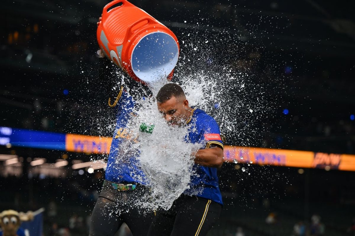 Sep 11, 2025; Seattle, Washington, USA; Seattle Mariners shortstop J.P. Crawford (3) dunks the water jug on pinch hitter Harry Ford (5) after the Mariners defeated the Los Angeles Angels at T-Mobile Park. Mandatory Credit: Steven Bisig-Imagn Images