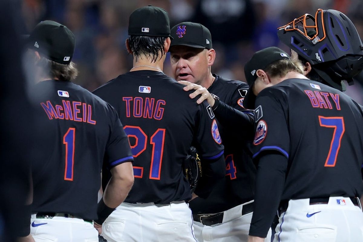 Sep 12, 2025; New York City, New York, USA; New York Mets manager Carlos Mendoza (64) takes starting pitcher Jonah Tong (21) out of the game against the Texas Rangers during a pitching change during the first inning at Citi Field. Mandatory Credit: Brad Penner-Imagn Images