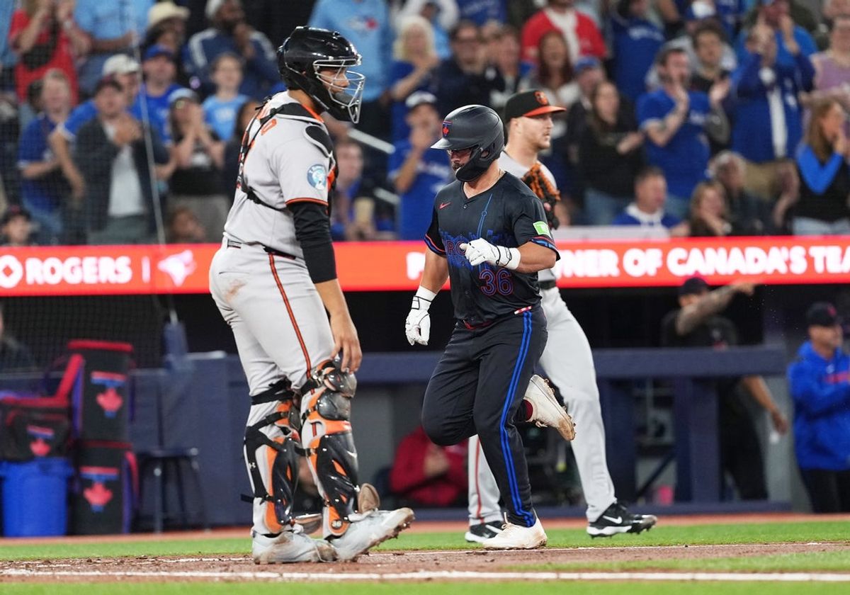 Sep 12, 2025; Toronto, Ontario, CAN; Toronto Blue Jays left fielder Davis Schneider (36) scores a run against the Baltimore Orioles during the fifth inning at Rogers Centre. Mandatory Credit: Nick Turchiaro-Imagn Images