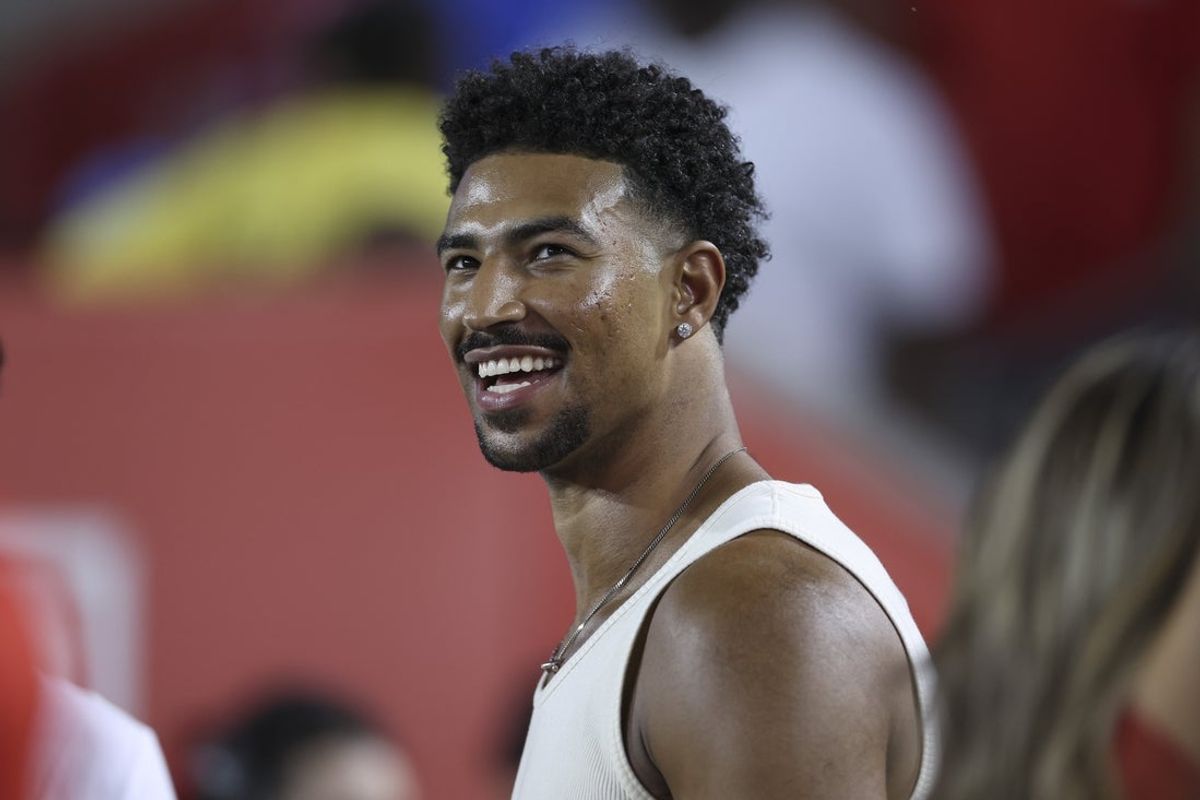 Sep 12, 2025; Houston, Texas, USA; Philadelphia 76ers player Quentin Grimes smiles while watching the game between the Houston Cougars and the Colorado Buffaloes at TDECU Stadium. Mandatory Credit: Troy Taormina-Imagn Images