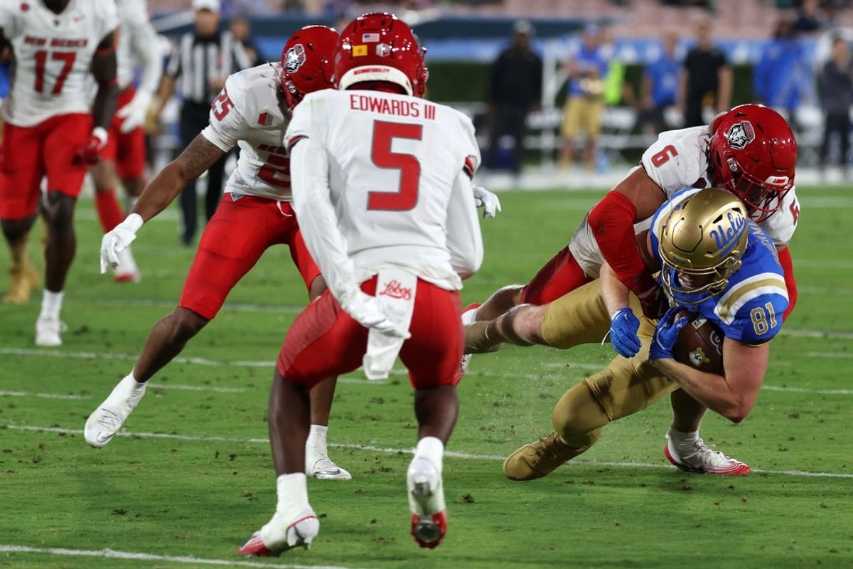 Sep 12, 2025; Pasadena, California, USA;  UCLA Bruins tight end Hudson Habermehl (81) is tackled by New Mexico Lobos defensive lineman Jaxton Eck (6) during the second quarter at Rose Bowl. Mandatory Credit: Kiyoshi Mio-Imagn Images