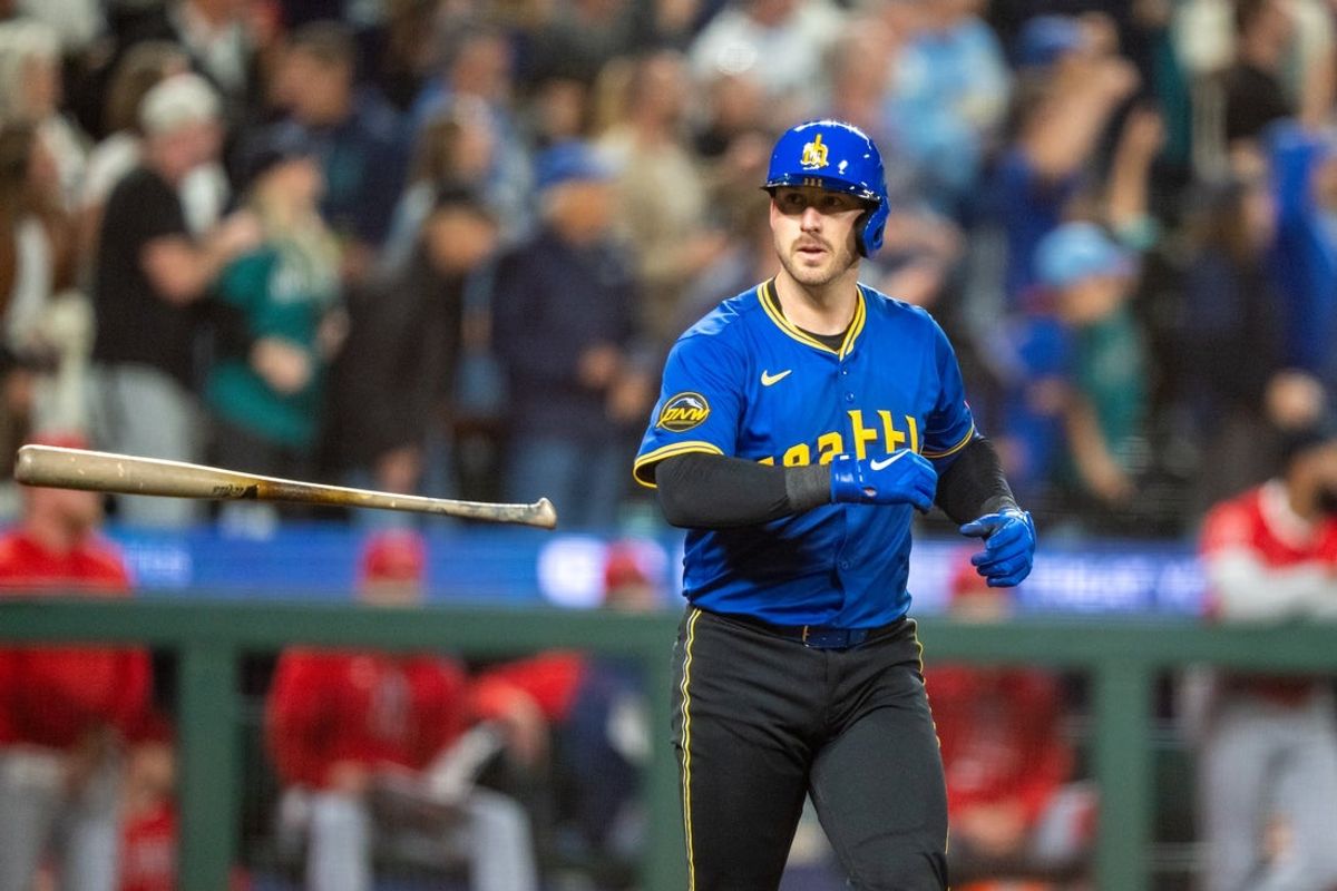 Sep 12, 2025; Seattle, Washington, USA; Seattle Mariners catcher Mitch Garver (18) flips his bat after hitting a solo home run during the seventh inning against the Los Angeles Angels  at T-Mobile Park. Mandatory Credit: Stephen Brashear-Imagn Images