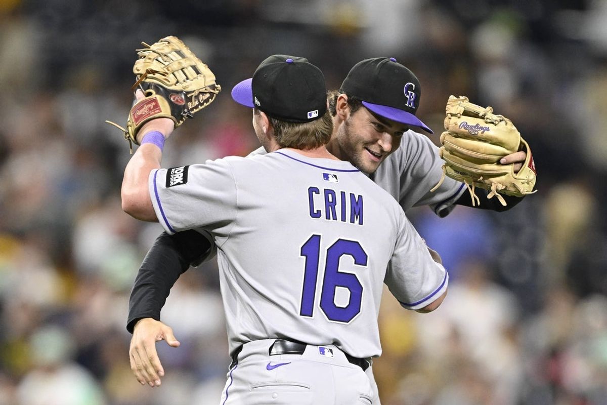 Sep 12, 2025; San Diego, California, USA; Colorado Rockies first baseman Blaine Crim (16) and Kyle Karros (12) celebrate after the Rockies beat the San Diego Padres at Petco Park. Mandatory Credit: Denis Poroy-Imagn Images