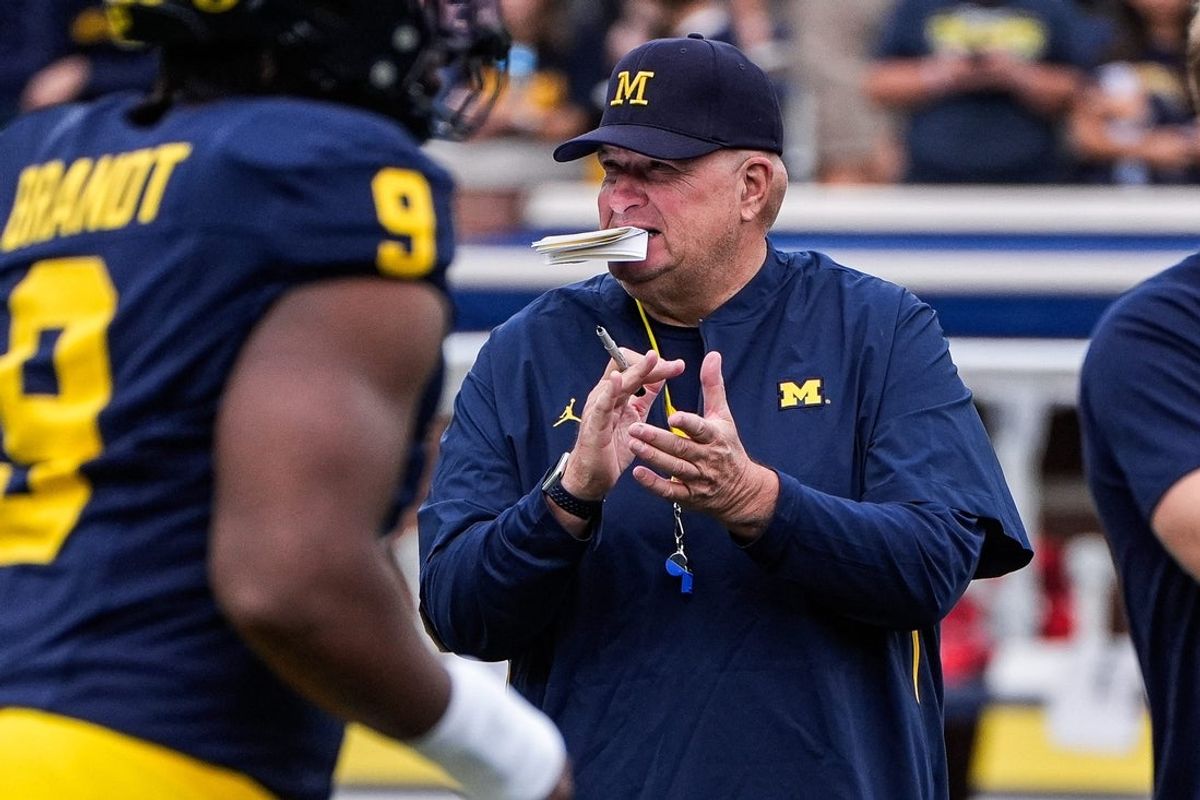 Michigan acting head coach Biff Poggi watches warm up before the Central Michigan game at Michigan Stadium in Ann Arbor on Saturday, Sept. 13, 2025.
