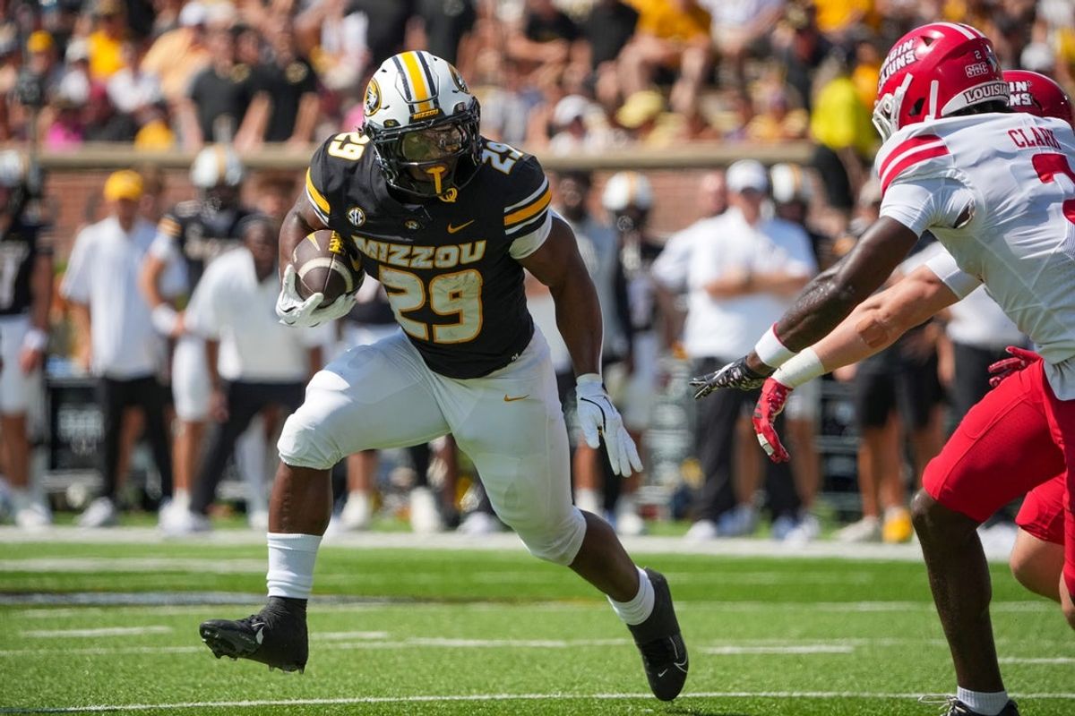 Sep 13, 2025; Columbia, Missouri, USA; Missouri Tigers running back Ahmad Hardy (29) runs the ball as Louisiana-Lafayette Ragin Cajuns safety Jalen Clark (2) defends during the first half of the game at Faurot Field at Memorial Stadium. Mandatory Credit: Denny Medley-Imagn Images