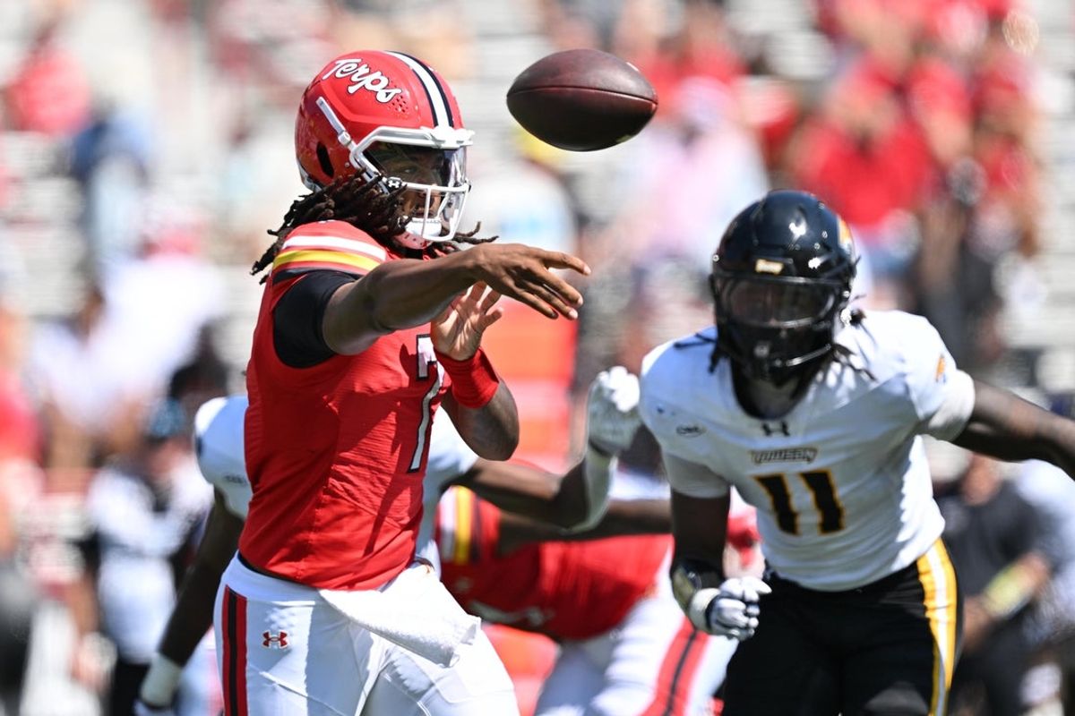 Sep 13, 2025; College Park, Maryland, USA;  Maryland Terrapins quarterback Malik Washington (7) passes in the first half against the Towson Tigers at SECU Stadium. Mandatory Credit: Jamie Sabau-Imagn Images