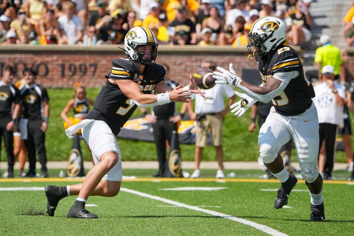 Sep 13, 2025; Columbia, Missouri, USA; Missouri Tigers quarterback Beau Pribula (9) pitches the ball to running back Ahmad Hardy (29) against the Louisiana-Lafayette Ragin Cajuns during the first half of the game at Faurot Field at Memorial Stadium. Mandatory Credit: Denny Medley-Imagn Images