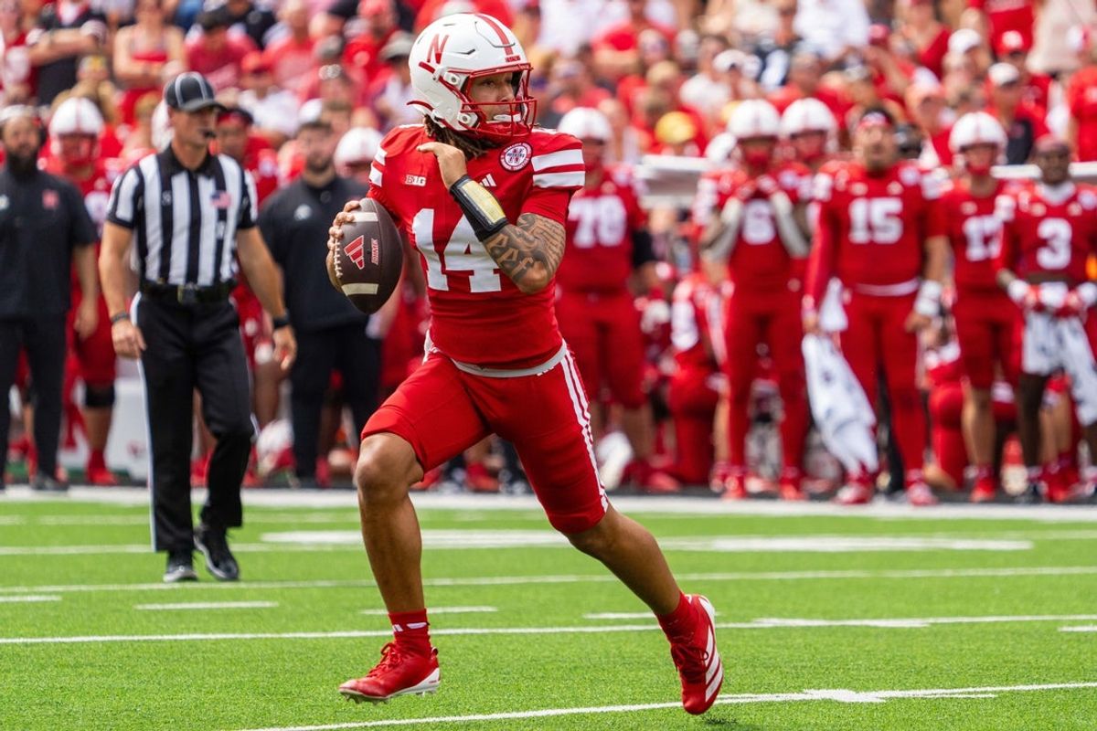 Sep 13, 2025; Lincoln, Nebraska, USA; Nebraska Cornhuskers quarterback TJ Lateef (14) scrambles against the Houston Christian Huskies during the third quarter at Memorial Stadium. Mandatory Credit: Dylan Widger-Imagn Images