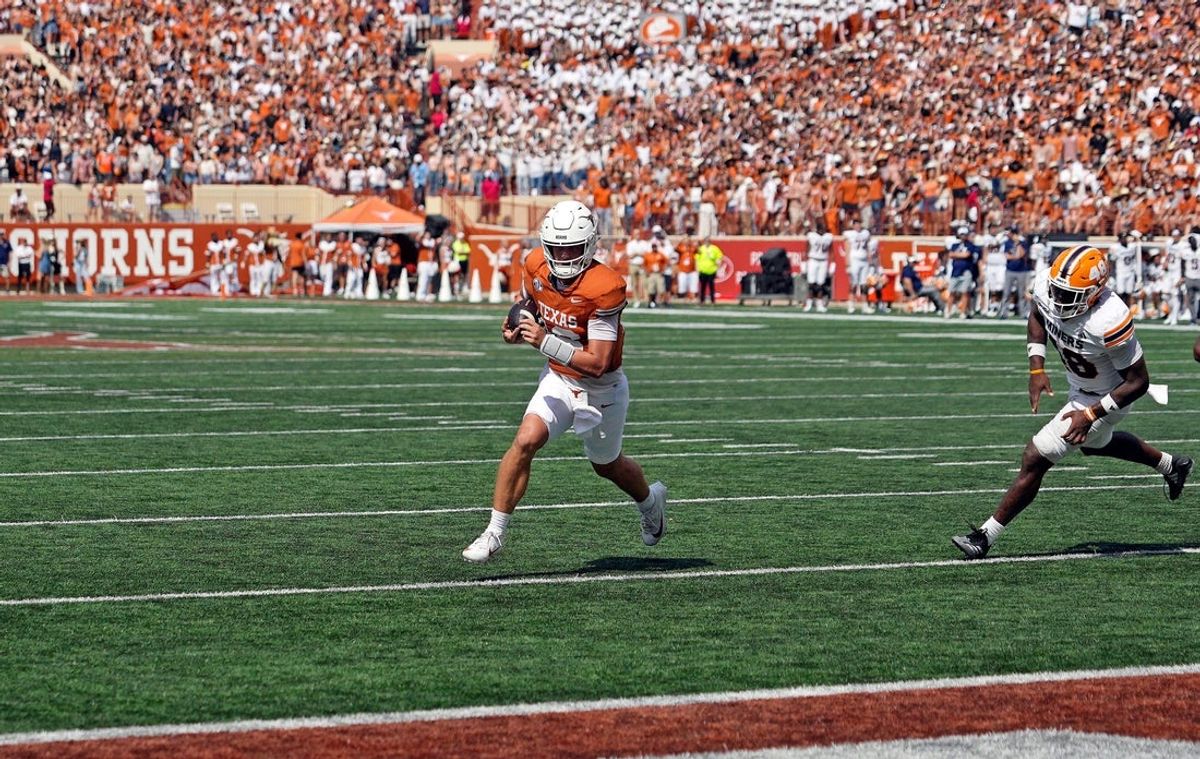 Sep 13, 2025; Austin, Texas, USA; Texas Longhorns quarterback Arch Manning (16) keeps the ball while running for a touchdown past Texas El Paso Miners linebacker Micah Davey (48) during the first half at Darrell K Royal-Texas Memorial Stadium. Mandatory Credit: Scott Wachter-Imagn Images