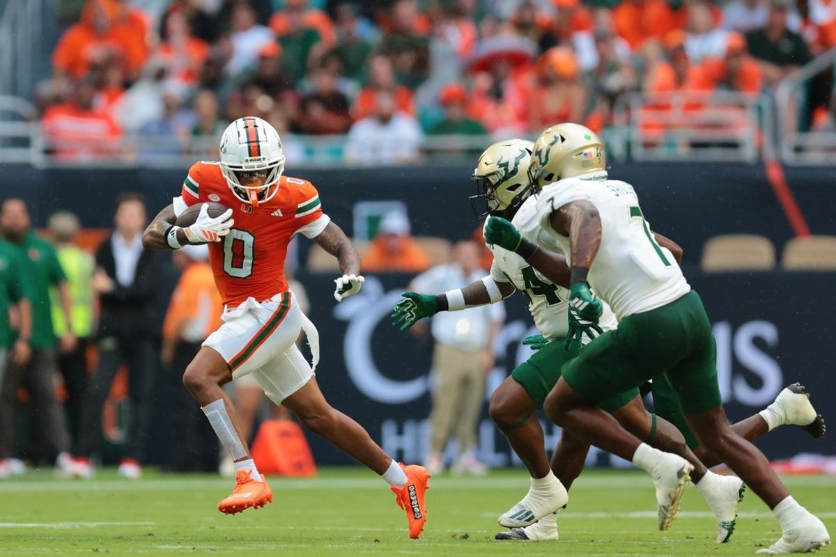 Sep 13, 2025; Miami Gardens, Florida, USA; Miami Hurricanes wide receiver Keelan Marion (0) runs with the football against the South Florida Bulls during the first quarter at Hard Rock Stadium. Mandatory Credit: Sam Navarro-Imagn Images