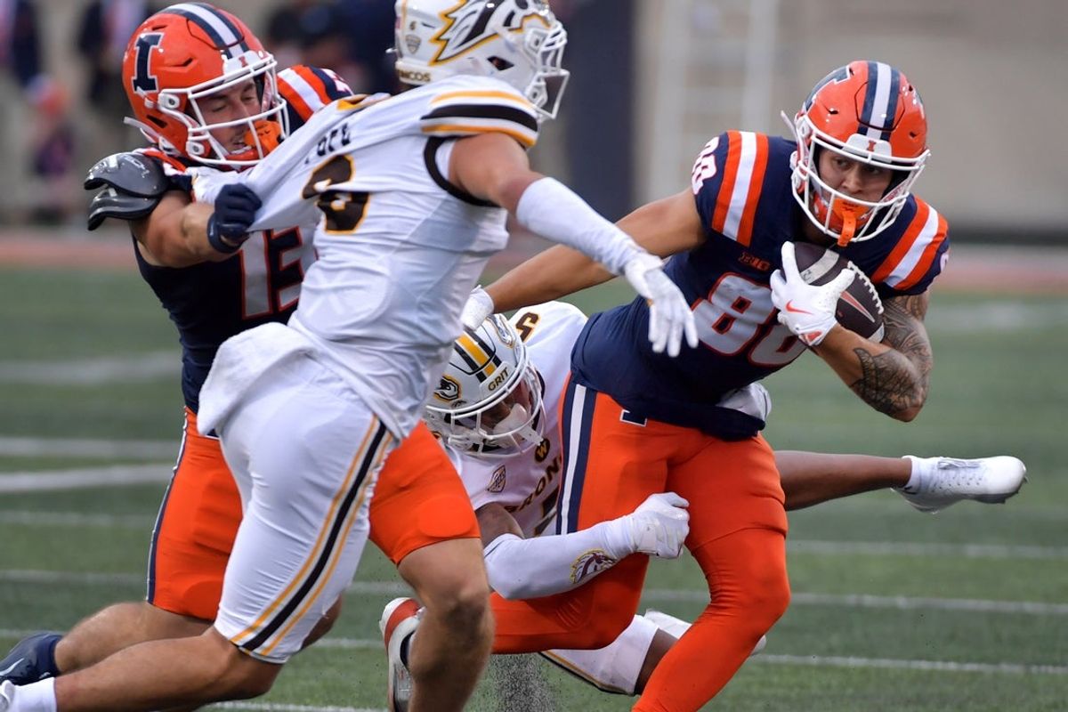 Sep 13, 2025; Champaign, Illinois, USA;  Illinois Fighting Illini wide receiver Hank Beatty (80) is tackled by Western Michigan Broncos cornerback Aaron Wofford (5) in the first half at Memorial Stadium. Mandatory Credit: Ron Johnson-Imagn Images