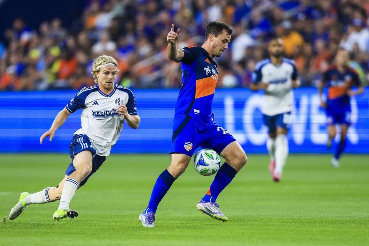 Sep 13, 2025; Cincinnati, Ohio, USA; FC Cincinnati midfielder Pavel Bucha (20) dribbles against Nashville SC midfielder Eddi Tagseth (20) in the first half at TQL Stadium. Mandatory Credit: Katie Stratman-Imagn Images