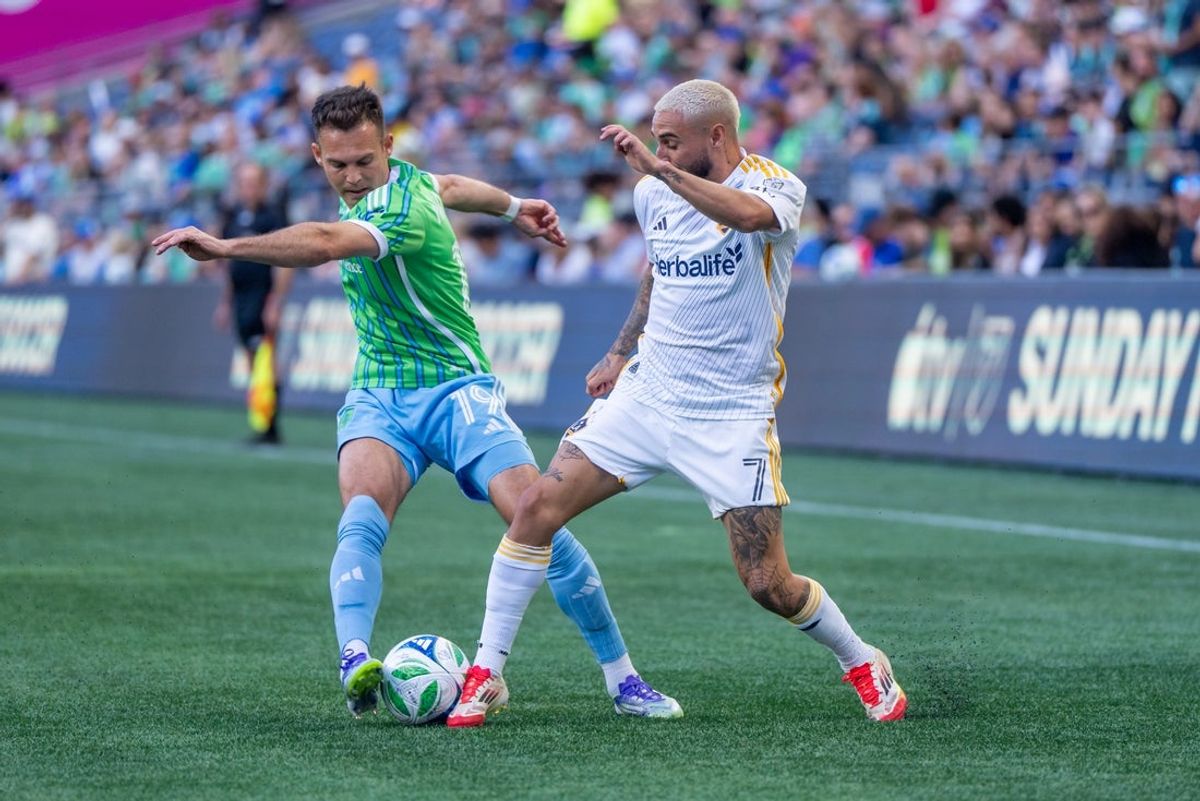 Sep 13, 2025; Seattle, Washington, USA; Seattle Sounders forward Daniel Musovski (19) and LA Galaxy midfielder Diego Fagundez (7) battle for the ball during the first half at Lumen Field. Mandatory Credit: Stephen Brashear-Imagn Images